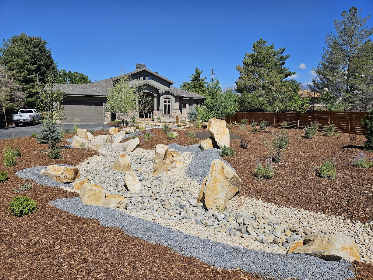 Real Scenic View Landscape project: a Utah home with boulder accents, gravel stream bed, and water-wise plantings