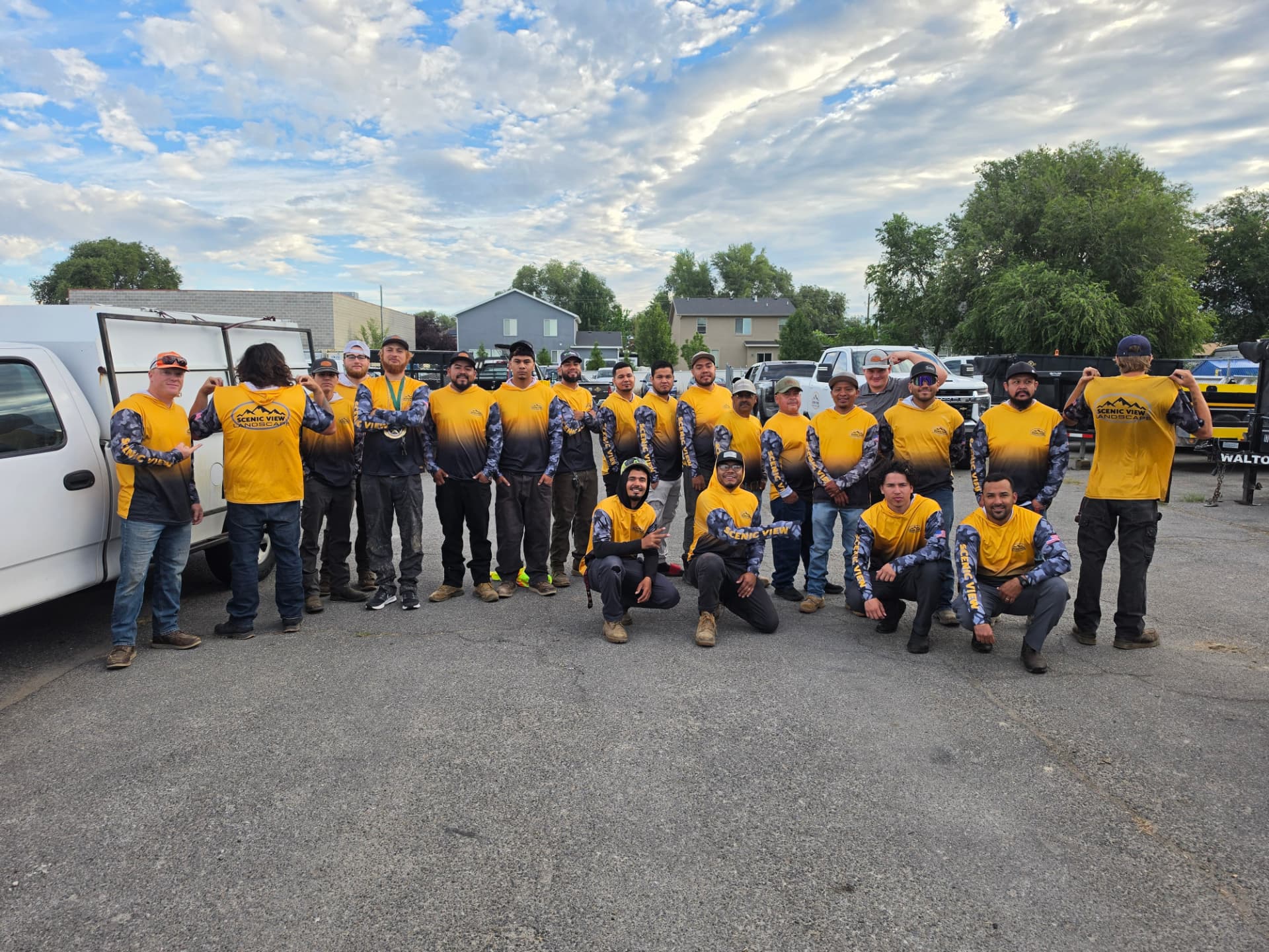 The Scenic View Landscape team gathered together in their gold and navy work shirts